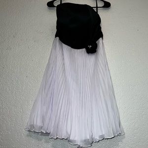 Strapless semi formal black and white dress with rhinestone flower.